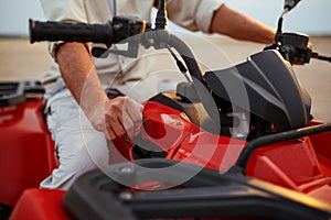 Atv racer in desert, closeup front view on hands