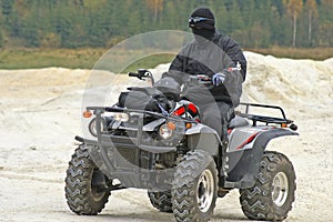 ATV rider with black mask