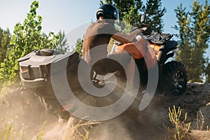 Atv rider climbing the sand mountain, back view