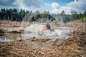 Atv rider in muddy water. Xtreme utv ride