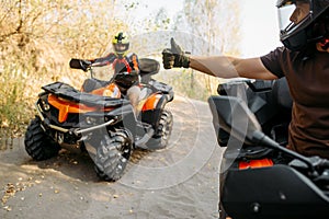 ATV rider showing thumbs up to his partner