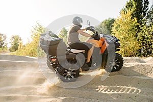 Atv riding in sand quarry, dust clouds, quad bike