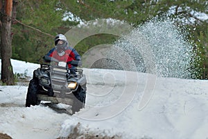 ATV and UTV driving in mud and snow at winter