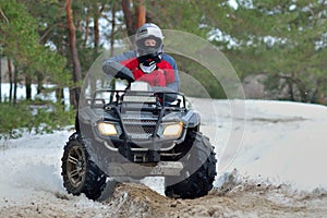 ATV and UTV driving in mud and snow at winter