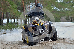 ATV and UTV driving in mud and snow at winter