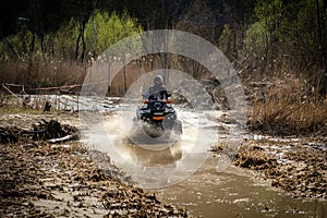 ATV and UTV rider driving in water hard road. Extreme offroad ride. 4x4