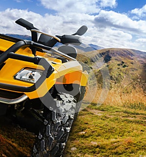 Atv vehicle standing on a mountain landscape offroad trail angle view