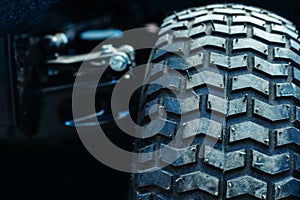 ATV wheel. Off-road tire tread on a dark background. Close-up