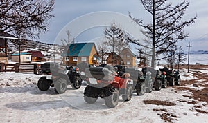 ATVs lined up on the snowy road