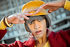 Atypical African American model lifting her hands up to head photo