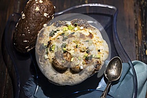 Au gratin served in a patty pan squash with bread.