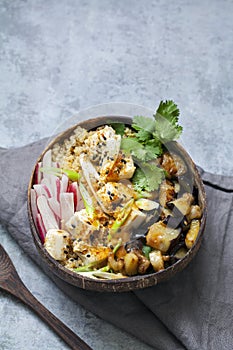 Aubergine, quinoa and tofu in coconut bowl