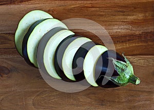 Aubergine slices, eggplant, on wooden board