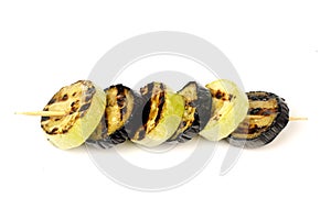 Aubergines and zucchini roasted on a grill on a spit