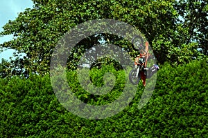 Auckland, New Zealand - Mar 2023. Dirtbike training in a park. A flying biker performing a dangerous jump.