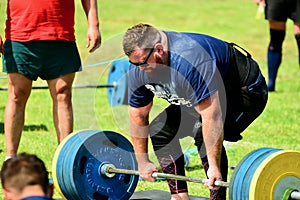 Auckland, New Zealand - Mar 2020. Strongman training in a public park, log Lift and Deadlift training