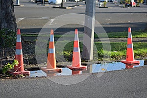AUCKLAND, NEW ZEALAND - Nov 06, 2020: road cones standing in puddle