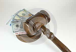 Auction Or Trial Concept With Auctioneers Judges Gavel And Scattered Money Heap On Wooden Table, Close Up,