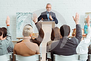 Auctioneer holding gavel and microphone and