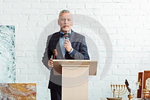 Auctioneer talking with microphone and holding