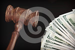 Auctioneers Hammer or Gavel With Money Heap On Black Background