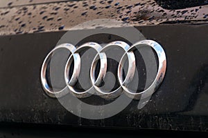 Audi company logo on wet car