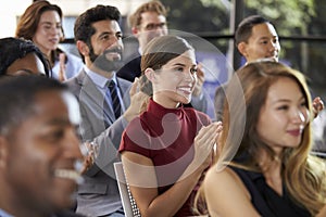 Audience applauding at a business seminar, close up