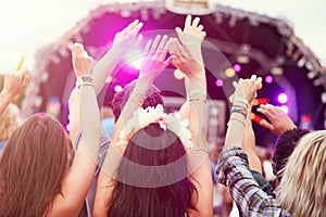 Audience with hands in the air at a music festival