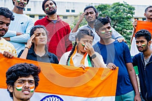 audience with indian flag got sad due to loss in cricket world cup match at stadium - concept of emotional, upset and
