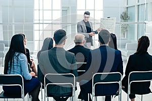 Audience listens to the lecturer in the conference room