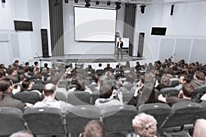 Audience listens to the report at the business conference