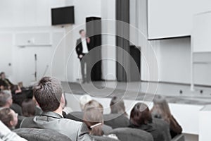 Audience listens to the speech of the leader at the business presentation.