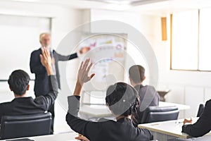 Audience in seminar raise hand up and want ask question to speaker