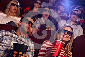 Audience watching 3D film at cinema