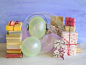 audio book as birthday gift with books,vintage headphones,balloons and decoration,free copy space