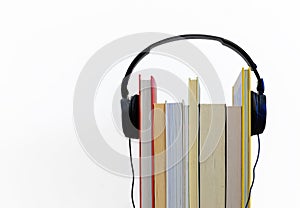 Audio book concept. Headphones and books on white