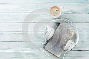 Audio book concept. Headphones, coffee and book