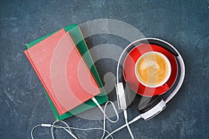Audio book concept with old book, headphones and coffee cup