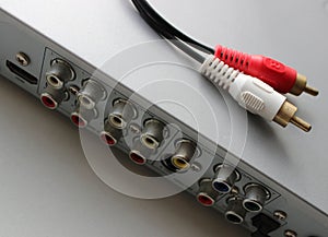 Audio cable with two colored RCA plugs is on the top panel of DVD player
