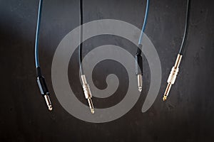 Audio Cables for electric guitar over Dark Background