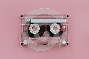 Audio cassette - analogue audio storage media. Audio cassette on pink background