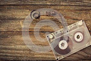 Audio cassette on the old wooden background.