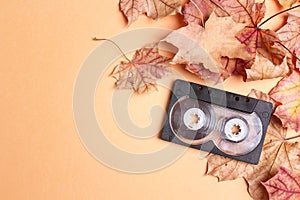 Audio cassette tape with autumn maple leaves and copy space. Mel