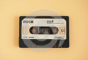 Audio cassette tape isolated on orange background, Vintage retro gadgets for The 70-80-90`s