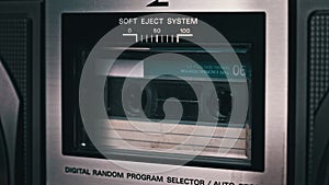 Audio Cassette Tape Rotates in Deck of an Old Tape Recorder