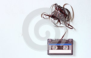 Audio cassette tape with subtracted out tape over blue textured wood board