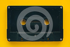 Audio cassette tape on yellow background