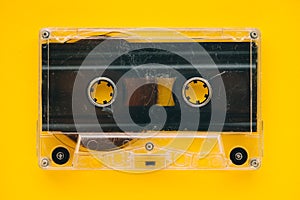 Audio cassette tape on yellow background