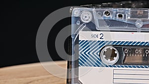 Audio cassettes Rotates on Black Background Close-Up