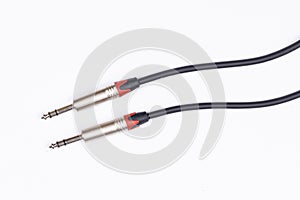 Audio guitar and microphone cable isolated above white background